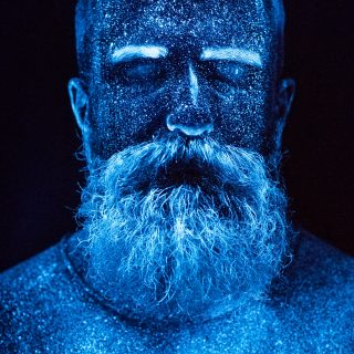 portrait three bearded men painted florescent powders